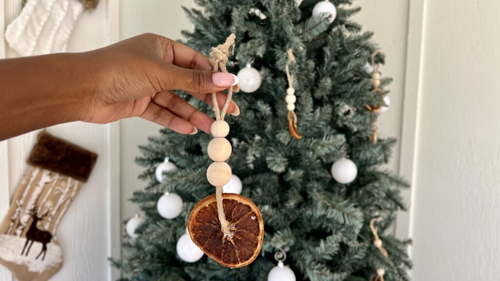 Holiday decor is photographed. A Christmas tree with diy ornaments made of orange slices
